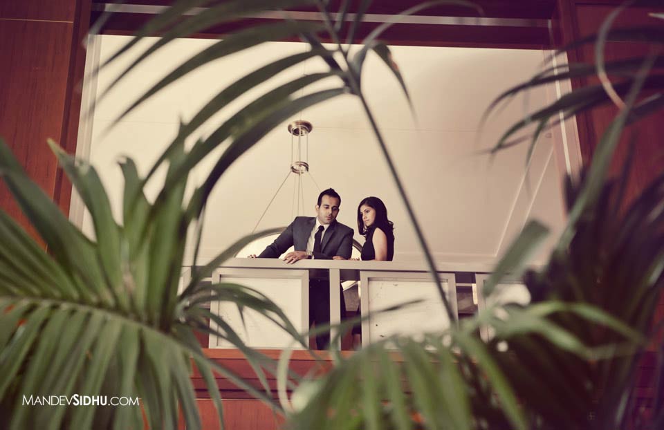 Corporate couple poses in downtown buidling