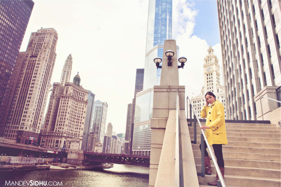 Model Standing on side of Chicago River with city skyline in background