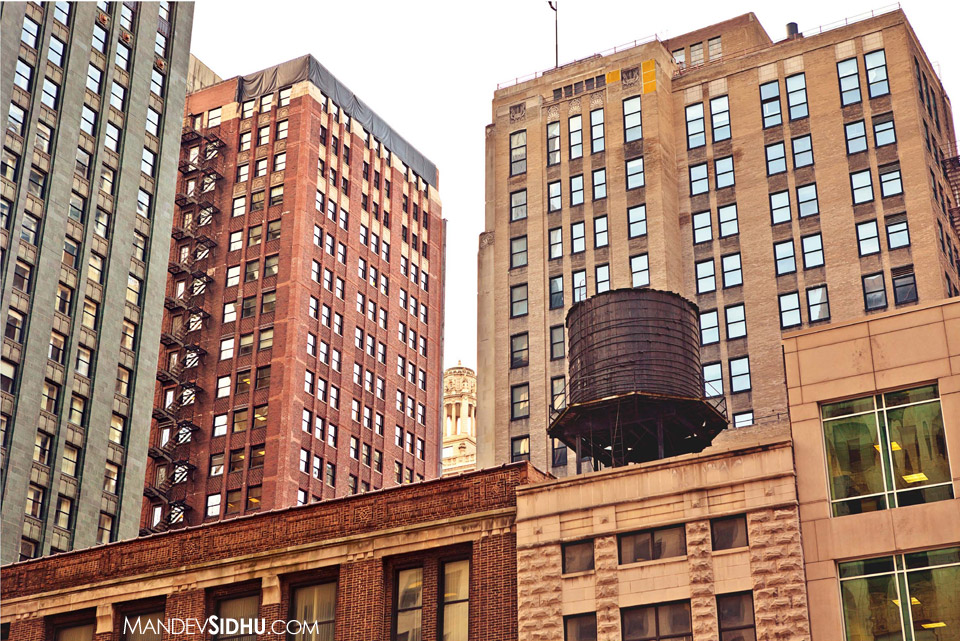 old water tower on top of building in downtown Chicago