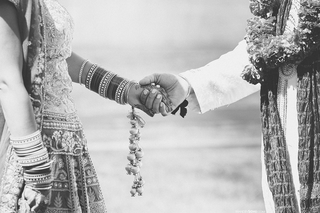 indian punjabi wedding couple holding hands